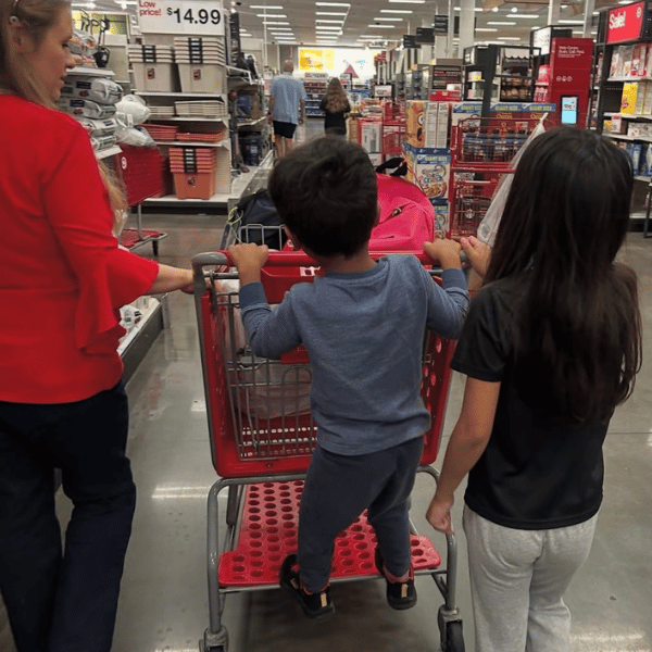 Volunteer Helping Child at Childspree Event