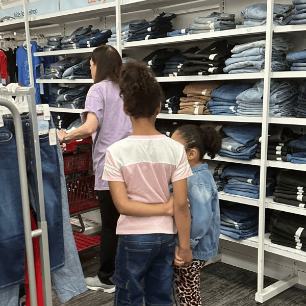 Volunteer Helping Child at Childspree Event